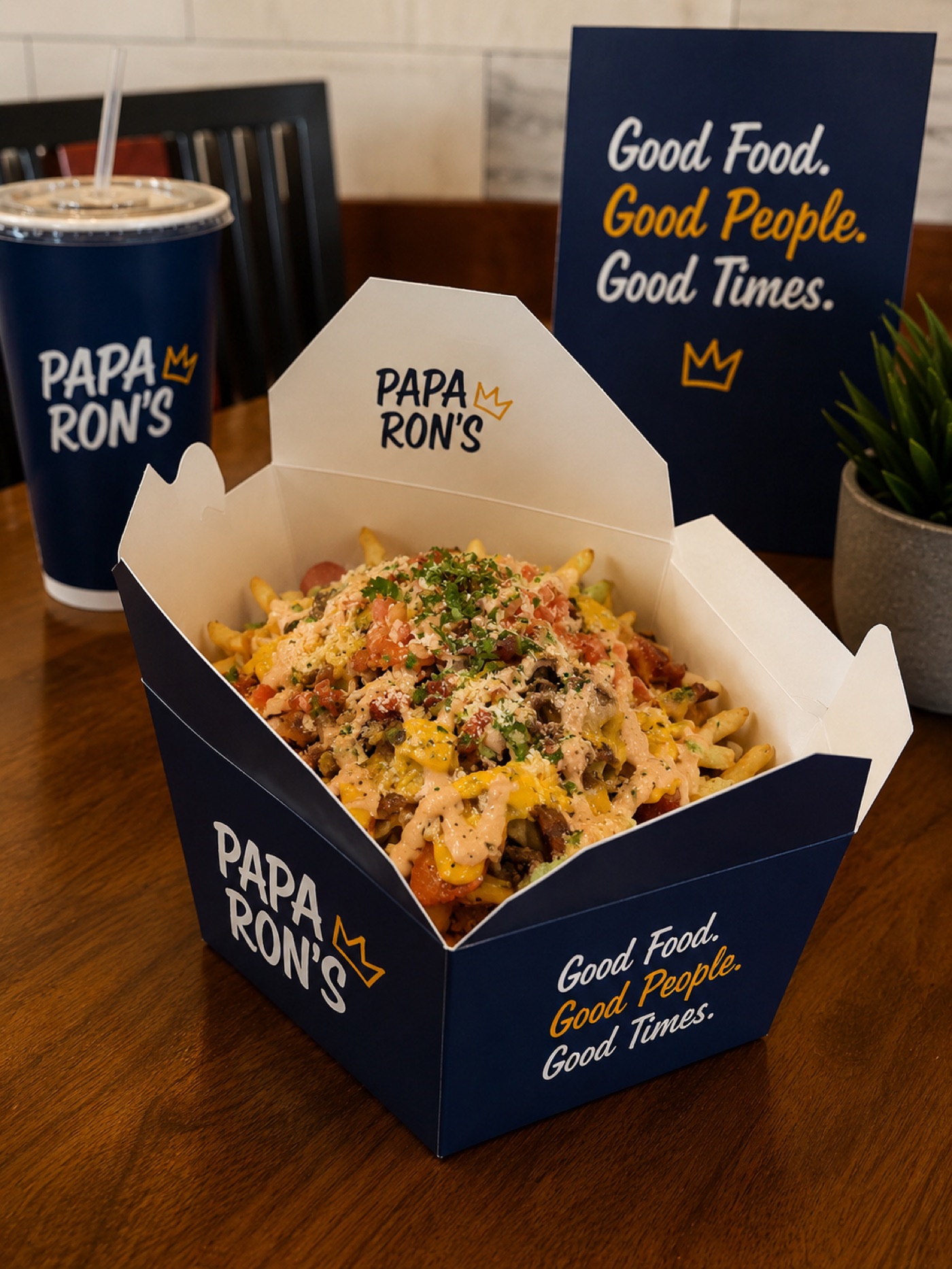 Papa Ron's loaded fries in a branded takeout box